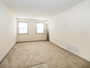Frederick apartment for rent - a room with a carpeted floor and two windows