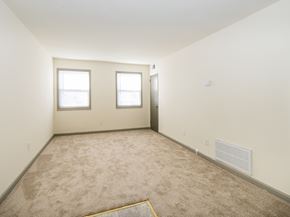 Frederick apartment for rent - a room with a carpeted floor and two windows