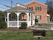Frederick apartment for rent - a gazebo with a picnic table in front of a house