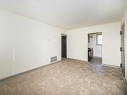 Frederick apartment for rent - an empty living room with white walls and a tiled floor