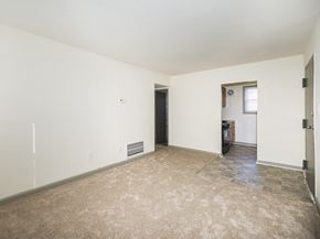 Frederick apartment for rent - an empty living room with white walls and a tiled floor