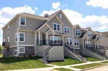 Olathe townhouse for rent - a row of houses with stairs and balconies