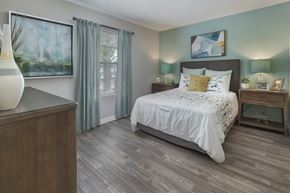 Orlando apartment for rent - a bedroom with a bed and a dresser and a window
