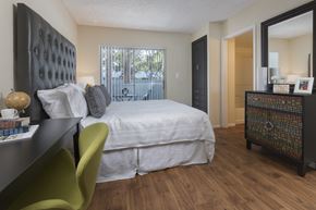 Davie apartment for rent - a bedroom with a bed and a desk and a window