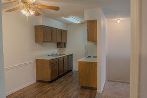 Omaha apartment for rent - A kitchen with wooden cabinets and a ceiling fan.