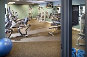 Boston apartment for rent - a gym with cardio equipment and weights on the floor