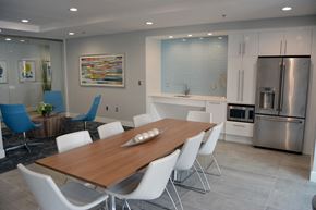 Boston apartment for rent - a dining room with a wooden table and white chairs
