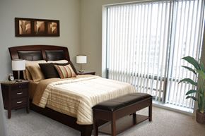 Boston apartment for rent - a bedroom with a bed and a large window