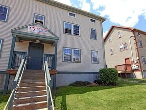 Fall River apartment for rent - an apartment building with stairs and a sign on it