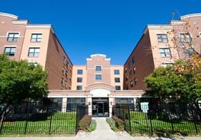 Chicago apartment for rent - a large brick building with a sidewalk in front of it