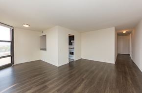 Chicago apartment for rent - an empty living room with wood flooring and a window