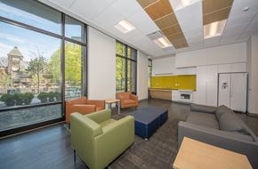 Chicago apartment for rent - a lounge area with couches and chairs in a room with large windows