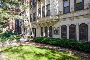 Chicago apartment for rent - the exterior of a building with a lawn and trees