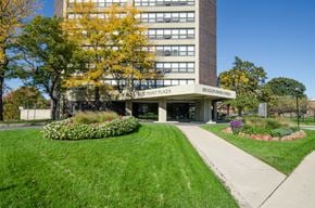 Chicago apartment for rent - the front of a building with a green lawn and flowers