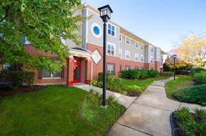 Chicago apartment for rent - a sidewalk in front of a brick building with a street light