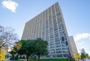 Chicago apartment for rent - a tall building with trees in front of it