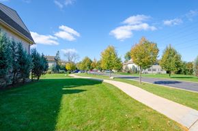 Chicago apartment for rent - a sidewalk running through a green lawn next to a street