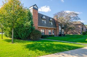 Chicago apartment for rent - A house with a red brick exterior and a grey roof.