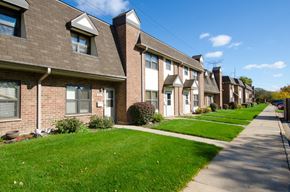 Chicago apartment for rent - a row of brick houses on the side of a sidewalk