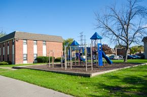 Chicago apartment for rent - a playground in front of a brick building