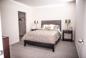 Green Bay apartment for rent - A bedroom with a bed, nightstands, and a closet.