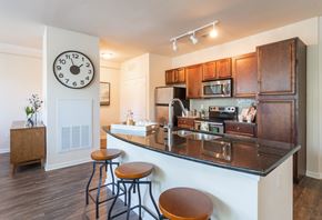 Mount Pleasant apartment for rent - a kitchen with a counter top and a large clock on the wall