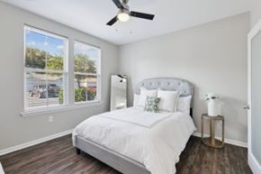 Mount Pleasant apartment for rent - A bedroom with a white bed and a ceiling fan.