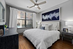 Raleigh apartment for rent - a bedroom with a bed and a ceiling fan