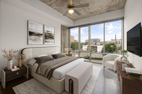 Raleigh apartment for rent - bedroom with large windows and furniture