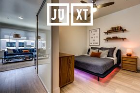 Seattle apartment for rent - a bedroom with a bed and a living room with a sliding glass door