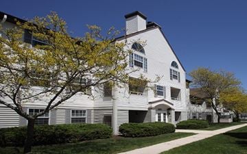 Sheboygan apartment for rent - a white house with a tree in front of it