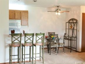 Oak Creek apartment for rent - a kitchen with bar stools and a table with chairs