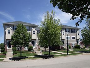 Cudahy condo for rent - an apartment building with stairs and trees in front of it