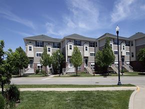 Cudahy condo for rent - an apartment building with stairs and trees in front of it