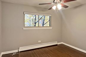 Oak Park apartment for rent - A room with a ceiling fan and a window.