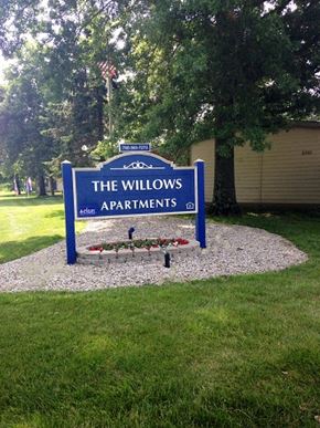 Delaware apartment for rent - a sign for the willows apartments in front of a lawn