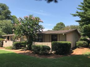 Augusta apartment for rent - a small tan house with a white fence