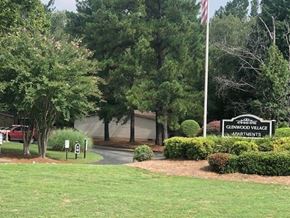 Macon apartment for rent - a building with a flag and a sign apartments