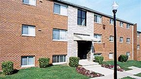 Baltimore apartment for rent - A brick building with a white doorway and windows.