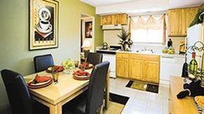 Baltimore apartment for rent - A dining table with chairs and a framed picture on the wall.