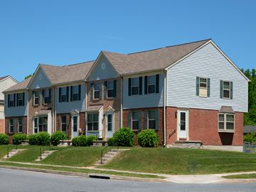 Baltimore apartment for rent - A row of houses with a blue sky in the background.