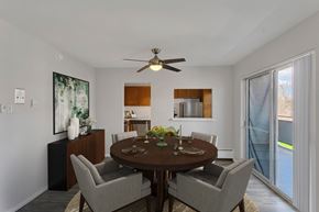 Denver apartment for rent - a dining room with a table and chairs and a ceiling fan