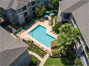 Houston apartment for rent - an aerial view of a swimming pool in front of a building