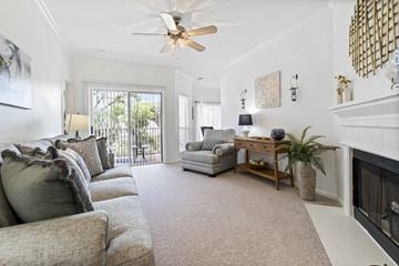 Houston townhouse for rent - A living room with a grey couch and a ceiling fan.