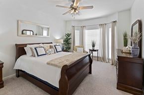 Houston townhouse for rent - A bedroom with a large bed and a ceiling fan.