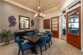 Katy apartment for rent - a dining room with a wooden table and blue chairs