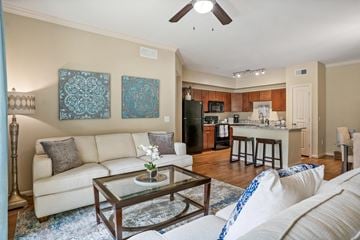 Conroe apartment for rent - A living room with a white couch and a glass coffee table.