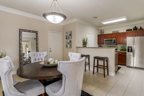 Houston apartment for rent - A modern dining room with a round table and chairs.