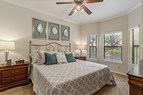 San Antonio apartment for rent - A bedroom with a large bed and a ceiling fan.