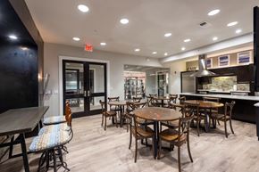 Houston apartment for rent - A modern bistro area with wooden chairs and tables.